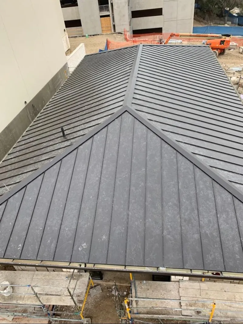 Commercial metal roof construction with crane equipment in Montevideo